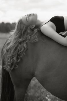 Outdoor art fashion photo of beautiful young lady with horse. 