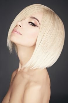 Fashion studio portrait of lovely asian woman with blonde short hair. Fashion and beauty. Bright makeup. Fashionable haircut                         