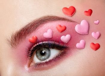 Eye Make-up Girl with a Heart. Valentine’s day Makeup. Beauty Fashion. Eyelashes. Cosmetic Eyeshadow. Makeup detail. Creative Woman Holiday make-up