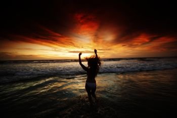 Happy Woman Jumping in Sea Sunset. Happy Woman in bikini Jumping in Sea Sunset