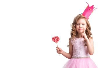 Little candy princess. Beautiful little candy princess girl in crown holding big pink heart lollipop and smiling