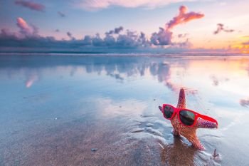 Starfish in sunglasses on sea beach. Starfish in sunglasses on sea beach at sunset, Bali, Seminyak, Double six beach