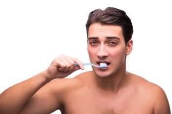 Handsome man brushing his teeth isolated on white