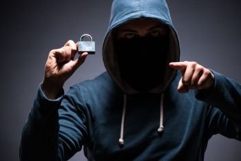 Hacker wearing hood in dark room