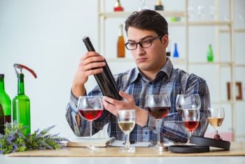 Professional sommelier tasting red wine 