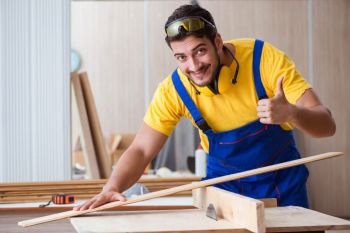 The young repairman carpenter working cutting wood. Young repairman carpenter working cutting wood
