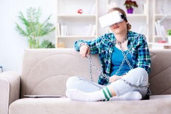 Chained female student with virtual glasses sitting on the sofa