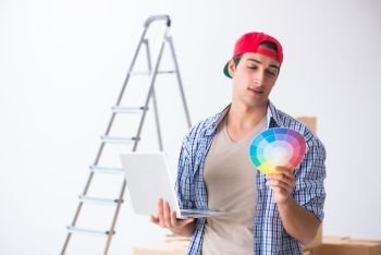 Young painter contractor choosing colors for home renovation