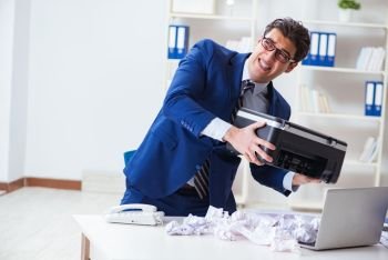 Businessman angry at copying machine jamming papers
