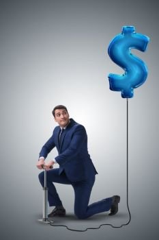 Businessman pumping dollar sign in business concept
