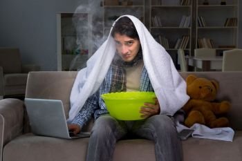 Sick man doing inhalation at night in home