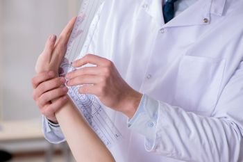 Doctor checking patients joint flexibility