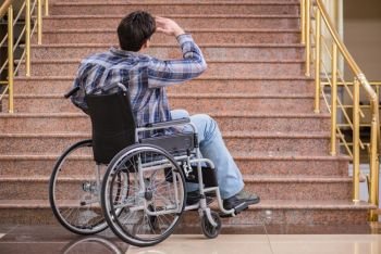 Disabled man on wheelchair having trouble with stairs