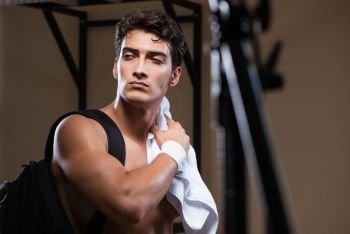 Man tired after workout in sports gym