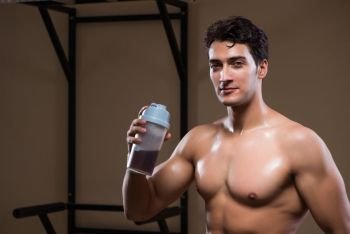 Man with nutrient supplements in sports gym