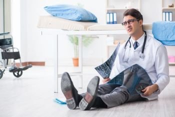 Doctor sitting on the floor in hospital