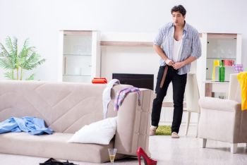 Man with mess at home after house party