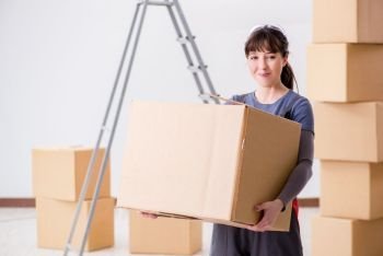 Woman contractor moving boxes in relocation concept