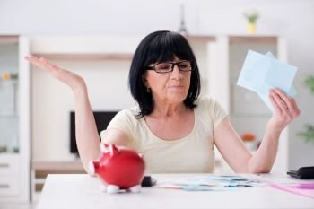 Mature woman trying to reconcile her bills