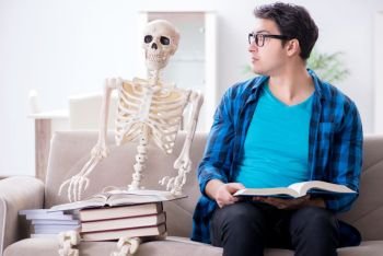 Student studying with skeleton preparing for exams