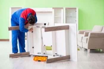 Repair contractor repairing broken furniture at home