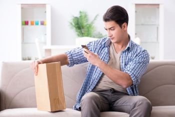 The man receiving parcel at home. Man receiving parcel at home. The man receiving parcel at home