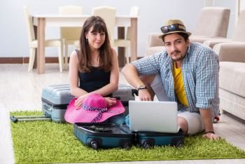 Young pair packing for summer vacation travel