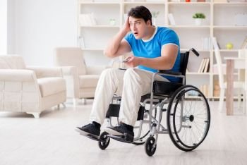 The disabled man watching sports on tv. Disabled man watching sports on tv