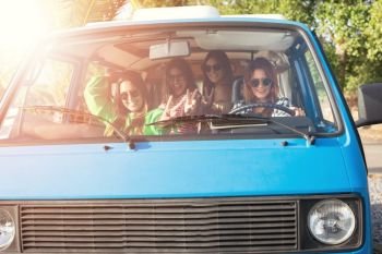 Summer holidays, road trip, vacation, travel and people concept - smiling young hippie women in car