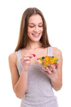 Jelly gummy bears! I love them!. Young woman holding a bowl of jelly gummy bears, isolated over white background