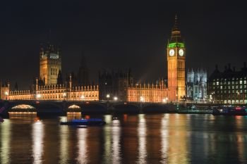England, London, Houses of Parliament. Houses of Parliament with Big Ben and Westminster Bridge at night in London.. Landscape image of the London skyline at night looking along the River Thames