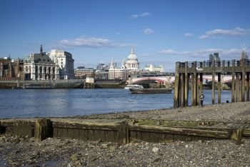 England, London, Southbank. Low tide on the River Thames.. Beautiful London city skyline landscape on blue sky Summer day