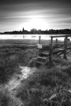 Landscapes. Black and white low tide landscape of Bosham Harbour with private jetty.