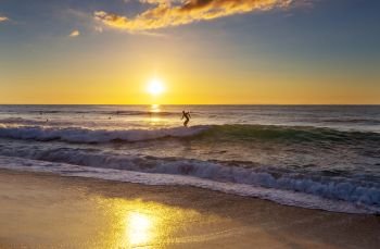 Surfing. Hawaiian surfing beach at sunset