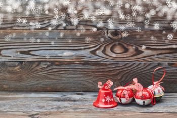 Christmas jingle bells decoration on wooden background