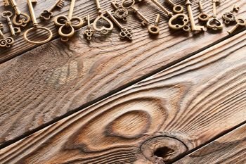 Various metal keys over wooden background