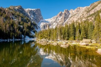 Dream Lake, Rocky Mountains, Colorado, USA. . Dream Lake and reflection with mountains in snow around at autumn. Rocky Mountain National Park in Colorado, USA. 