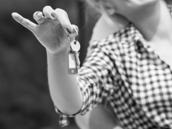 Closeup of woman holding house keys in arm