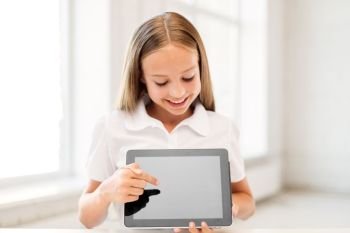 education, technology and people concept - happy smiling student girl pointing finger to tablet pc computer screen at school. smiling student girl with tablet pc computer