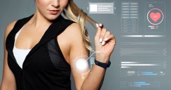 sport, technology and people concept - close up of young woman in black sportswear with fitness tracker posing in gym. close up of sporty woman with fitness tracker