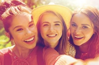 leisure, holidays and people concept - happy women or friends taking selfie at summer. happy women or friends taking selfie at summer