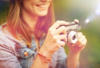 photography and people concept - close up of young woman with film camera photographing outdoors. close up of woman with camera shooting outdoors