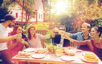 summer, holidays, celebration people and food concept - happy friends having garden party and clinking glasses. happy friends having party at summer garden