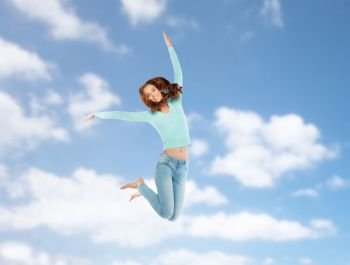 happiness, freedom, motion and people concept - smiling young woman jumping in air over blue sky background. smiling young woman jumping in air over blue sky