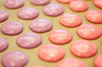 cooking, food and confectionery concept - macaron batter or meringue cream on baking paper at pastry shop. macaron batter or meringue cream on baking paper