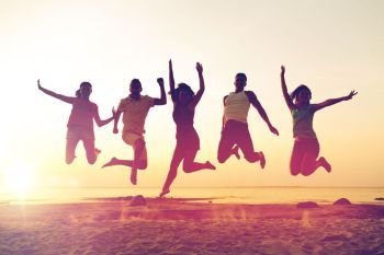 friendship, summer vacation, holidays, party and people concept - group of smiling friends dancing and jumping on beach. smiling friends dancing and jumping on beach