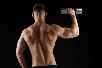 sport, bodybuilding, fitness and people concept - young man with dumbbells flexing muscles over black background from back. man with dumbbells exercising