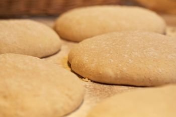 food, cooking and baking concept - close up of yeast bread dough rising at bakery. close up of yeast bread dough at bakery