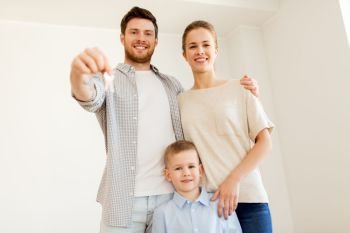 mortgage, people, housing and real estate concept - happy family with key moving to new home. happy family with key moving to new home