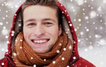 people, christmas, winter and season concept - close up of happy smiling man in hood and scarf outdoors. close up of happy man in winter jacket with hood